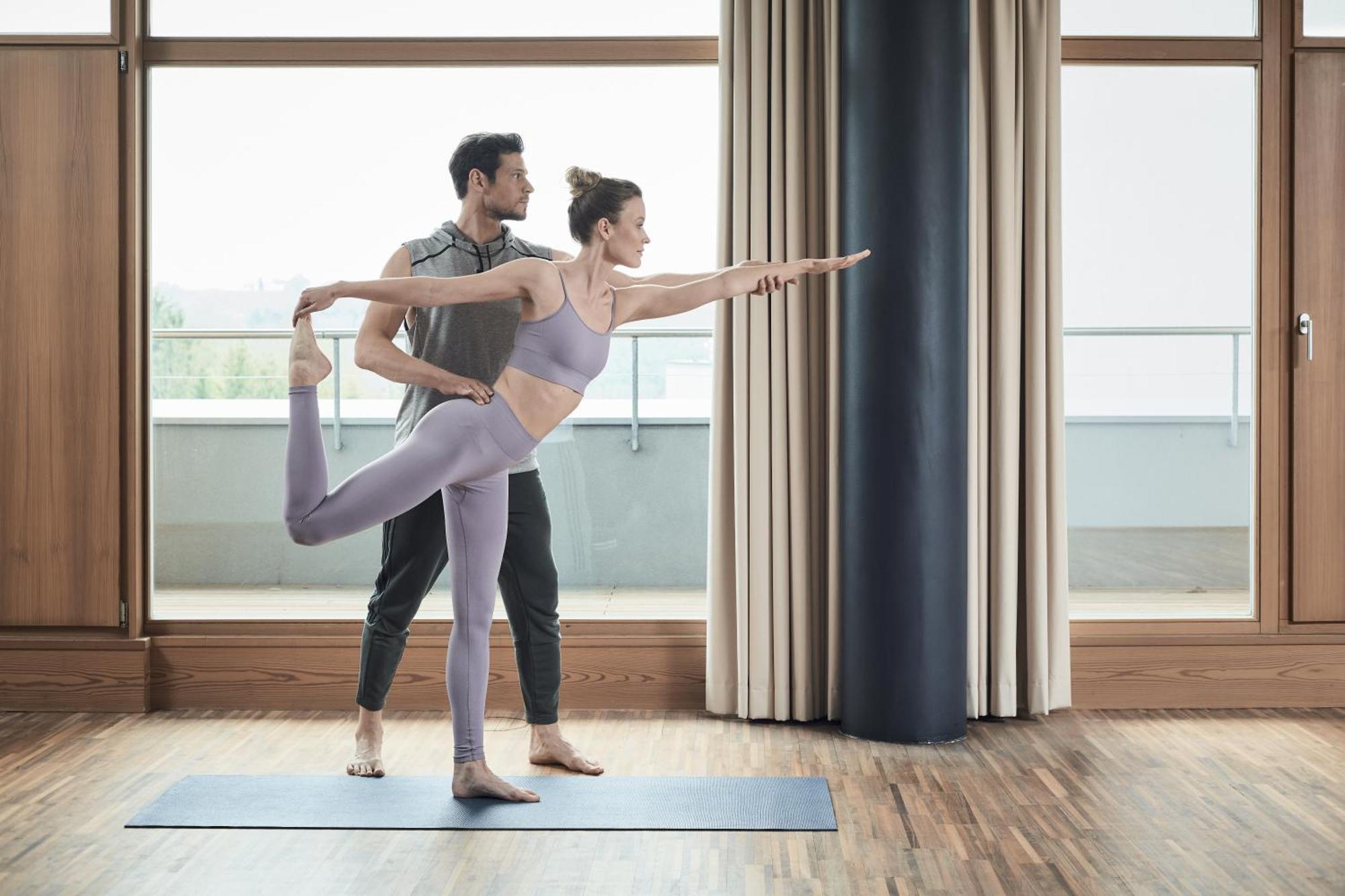 Falkensteiner Balance Resort Stegersbach - Adults Only Εξωτερικό φωτογραφία A woman practicing yoga with a personal trainer